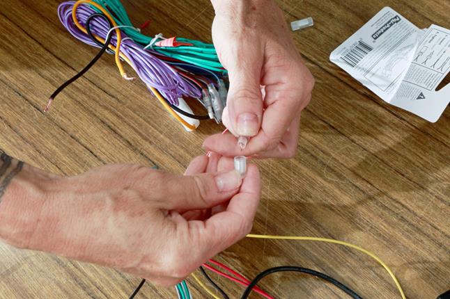 Alex uses Posi-Product connectors to connect the radio's wiring to the Axxess interface.